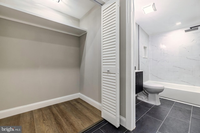 bathroom with toilet, tile patterned floors, and vanity