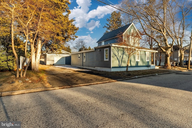 view of front of house featuring an outdoor structure and a garage