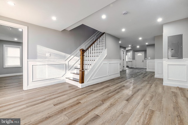 unfurnished living room with light hardwood / wood-style flooring and electric panel