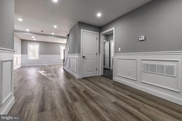 unfurnished living room with dark hardwood / wood-style flooring