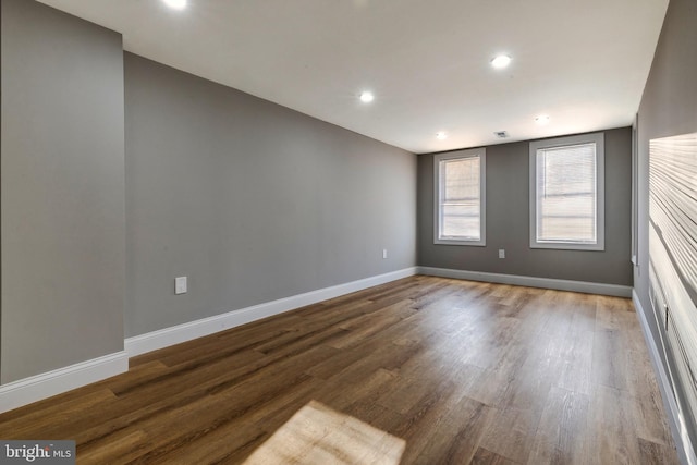 empty room with hardwood / wood-style floors