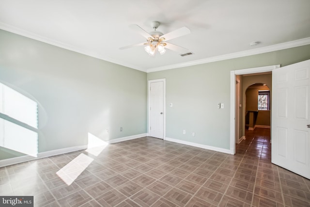 spare room featuring ceiling fan and ornamental molding