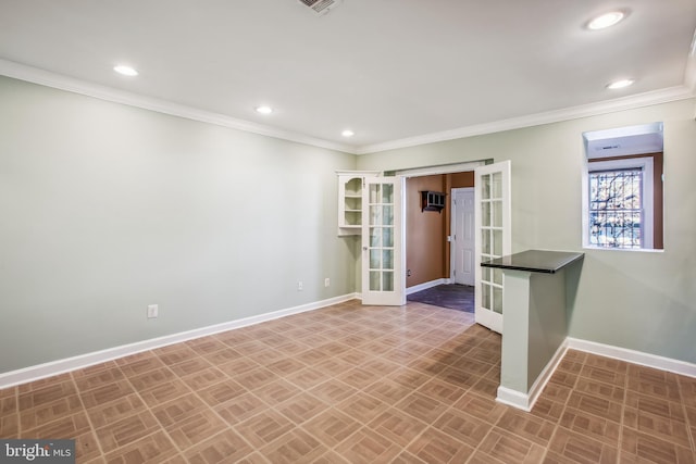 unfurnished room featuring french doors, a wall mounted AC, and crown molding