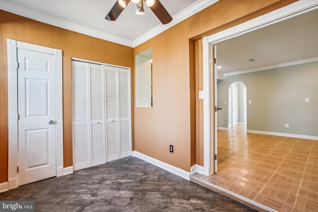 unfurnished bedroom with a closet, ceiling fan, and ornamental molding