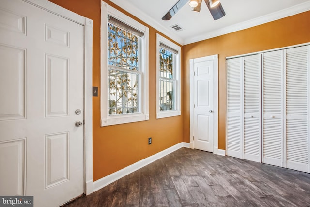 interior space featuring ceiling fan, dark hardwood / wood-style flooring, and crown molding