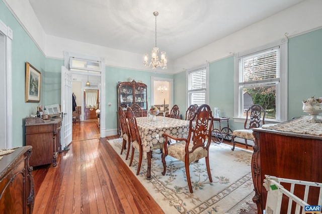 dining room with a chandelier and dark hardwood / wood-style floors