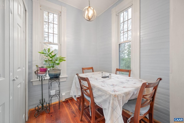 dining space with dark hardwood / wood-style flooring and a baseboard radiator