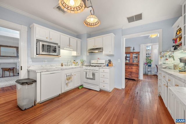 kitchen featuring white appliances, sink, crown molding, light hardwood / wood-style floors, and white cabinetry