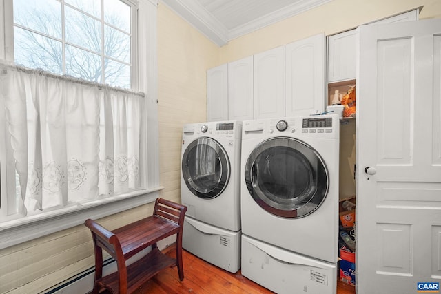 washroom featuring cabinets, light hardwood / wood-style floors, washer and dryer, and ornamental molding