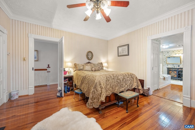 bedroom with ceiling fan, crown molding, a textured ceiling, and hardwood / wood-style flooring