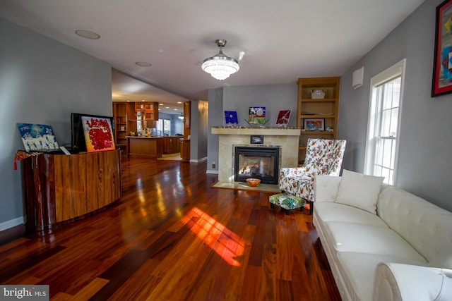 living room featuring wood-type flooring and a notable chandelier