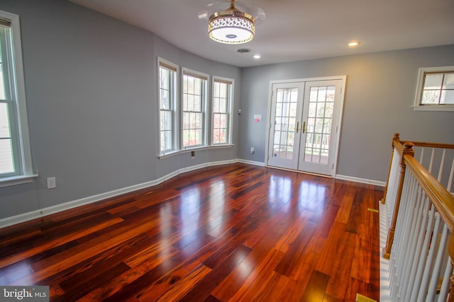 unfurnished room with french doors, dark hardwood / wood-style flooring, and plenty of natural light