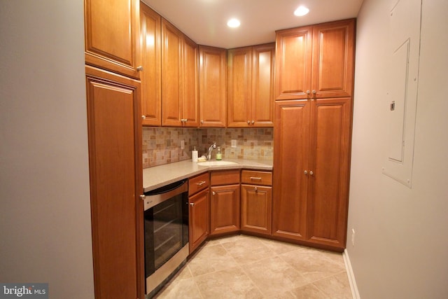 kitchen with decorative backsplash, light tile patterned floors, wine cooler, and sink