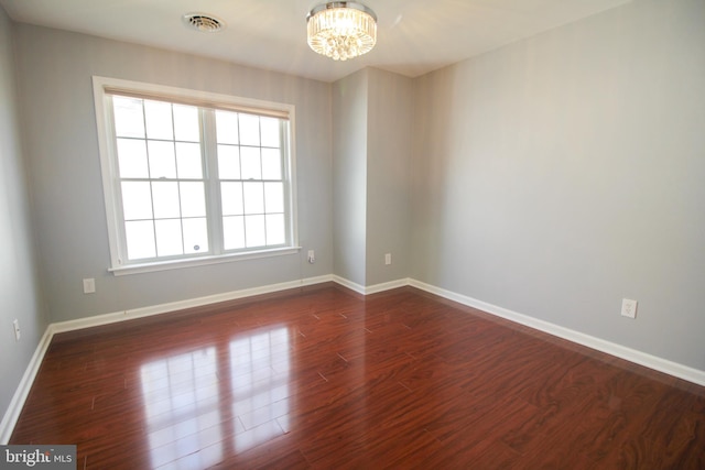 unfurnished room featuring plenty of natural light and dark hardwood / wood-style floors