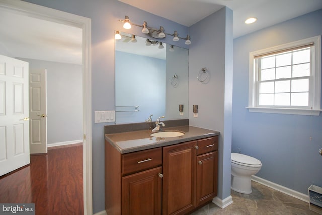 bathroom featuring hardwood / wood-style flooring, vanity, and toilet