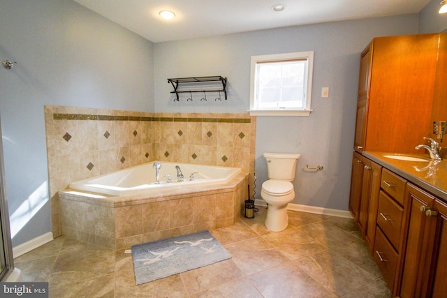 bathroom with tile patterned flooring, a relaxing tiled tub, toilet, and vanity