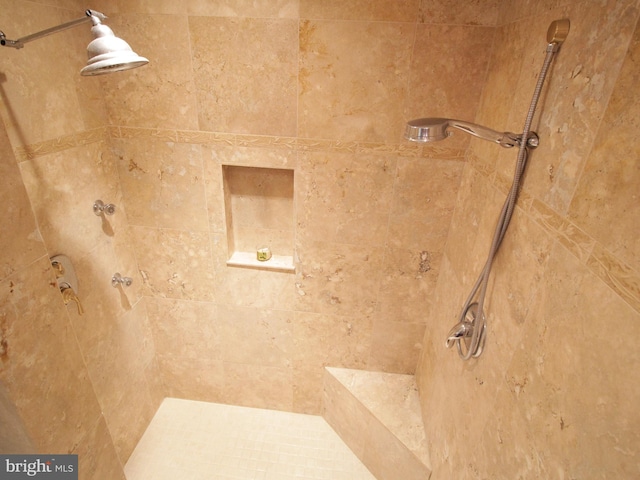 bathroom with tiled shower