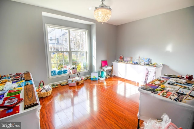 playroom featuring hardwood / wood-style flooring and a notable chandelier