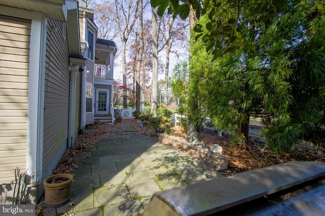 view of yard with a balcony and a patio area