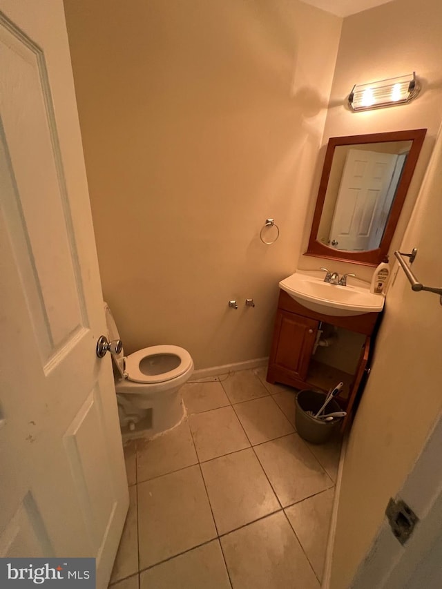 bathroom with tile patterned flooring, vanity, and toilet