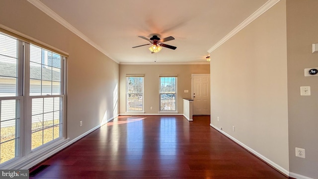 unfurnished room with ornamental molding, dark wood-type flooring, and ceiling fan