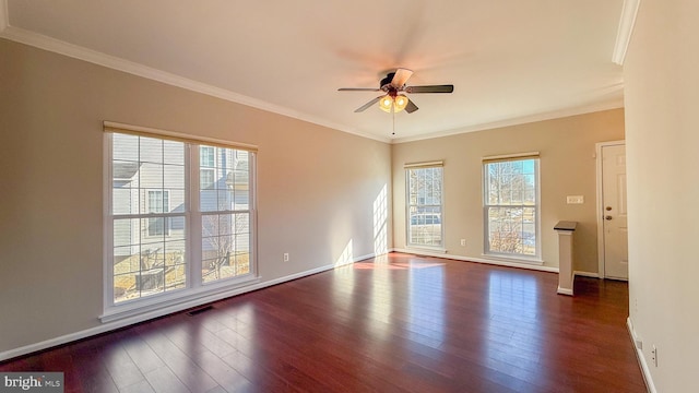 spare room featuring crown molding and dark hardwood / wood-style floors