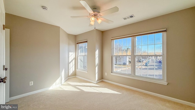 empty room with light colored carpet and ceiling fan