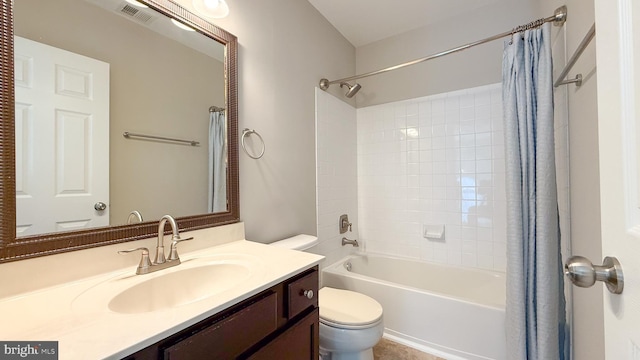 full bathroom featuring shower / bath combo with shower curtain, vanity, and toilet