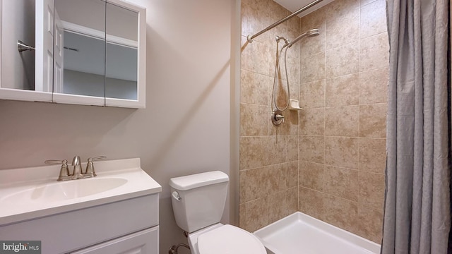 bathroom featuring toilet, vanity, and curtained shower