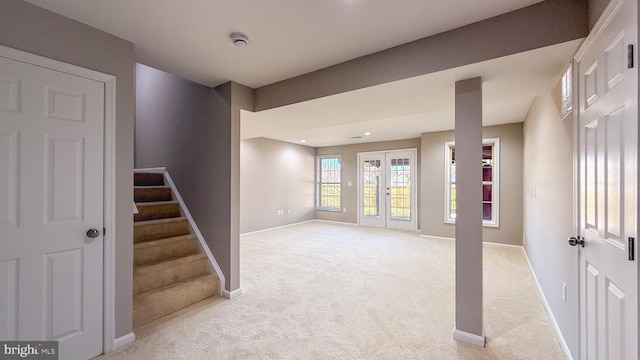 basement with french doors and light carpet