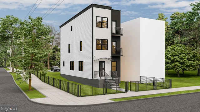 view of front facade featuring a front lawn and a balcony