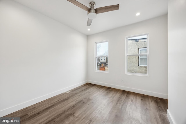 empty room featuring ceiling fan and hardwood / wood-style floors