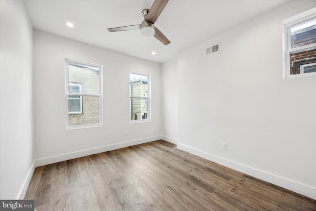 empty room featuring ceiling fan and hardwood / wood-style flooring