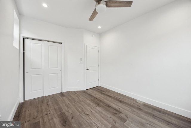 unfurnished bedroom featuring hardwood / wood-style flooring, ceiling fan, and a closet