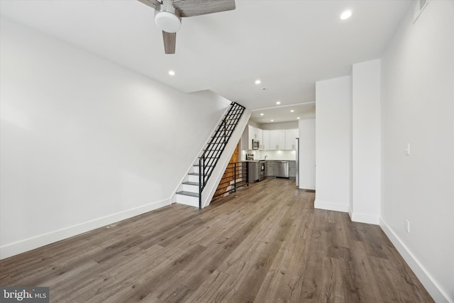 unfurnished living room with light hardwood / wood-style flooring and ceiling fan