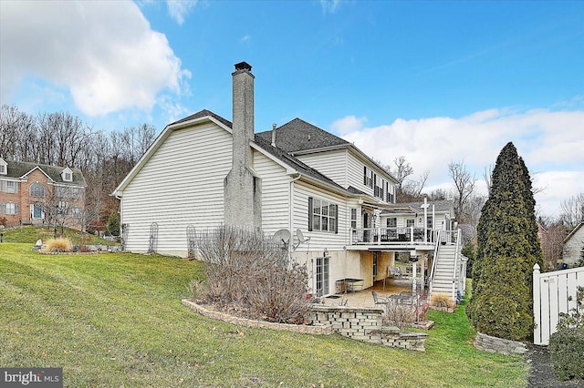 back of property with a patio area, a yard, and a wooden deck