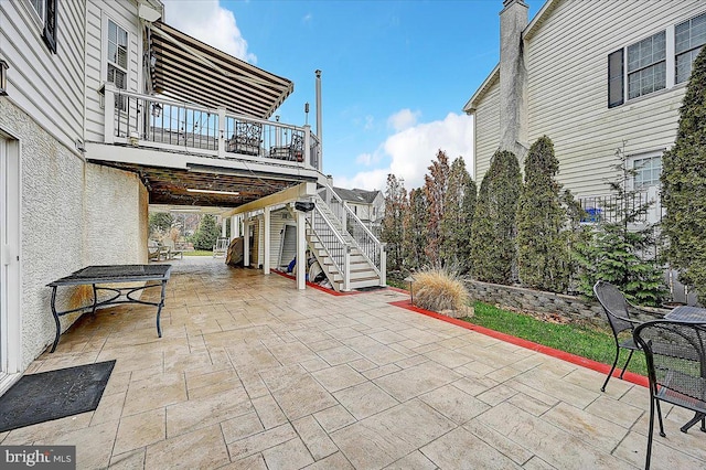 view of patio featuring a balcony