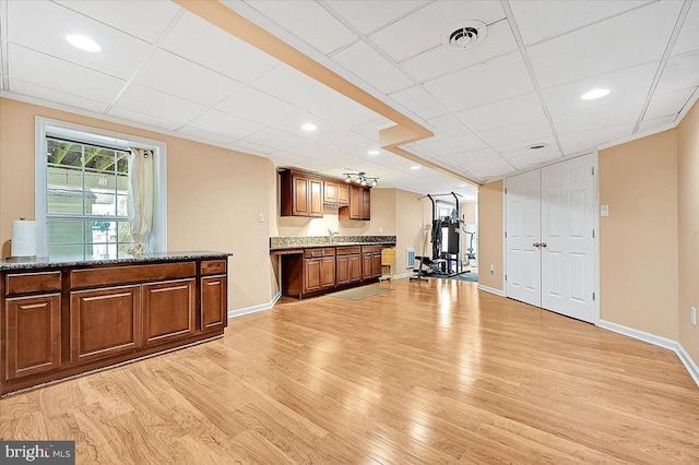 kitchen featuring gas water heater, sink, and light hardwood / wood-style flooring