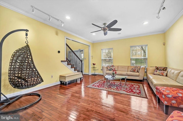 living room with hardwood / wood-style flooring, ceiling fan, and ornamental molding