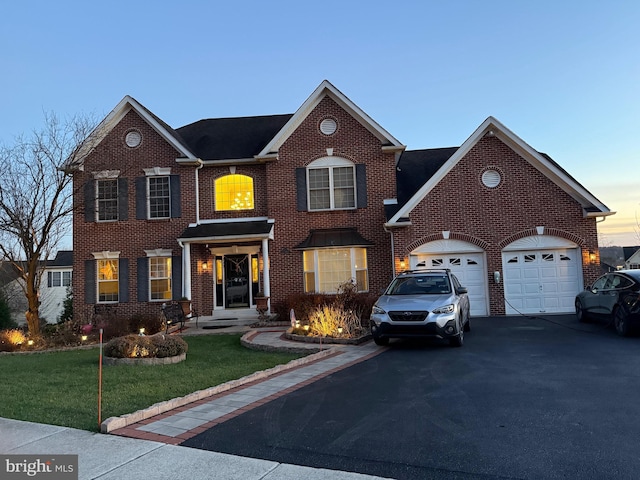 view of front facade featuring a lawn and a garage