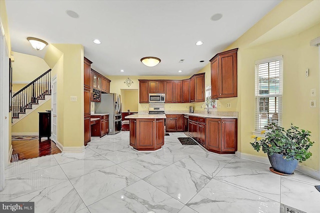 kitchen with a center island, stainless steel appliances, and sink