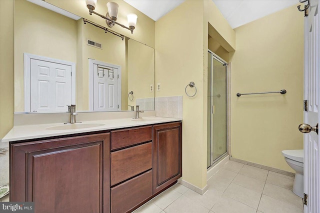 bathroom featuring tile patterned floors, toilet, an enclosed shower, and vanity