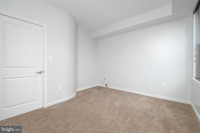 spare room with carpet floors and baseboards