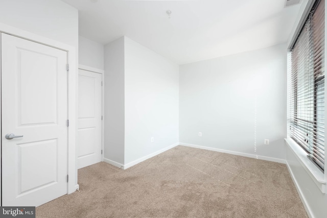 unfurnished bedroom featuring carpet and baseboards