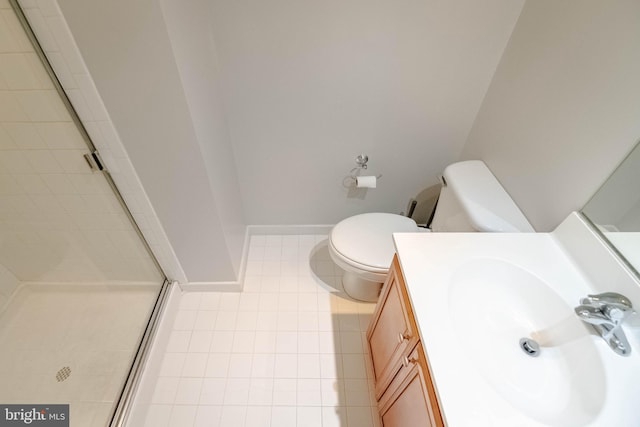 bathroom with toilet, vanity, baseboards, tile patterned floors, and a stall shower