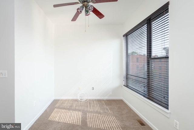 carpeted empty room featuring baseboards and visible vents