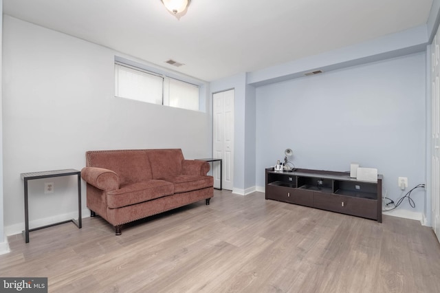 sitting room featuring visible vents, baseboards, and wood finished floors