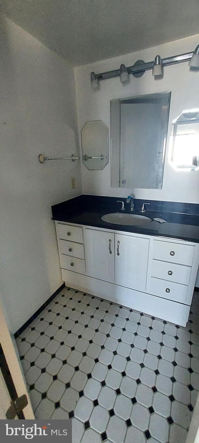 bathroom featuring a textured ceiling and vanity