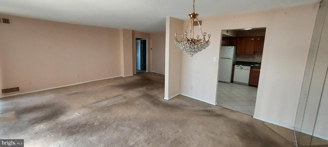 unfurnished dining area with a chandelier