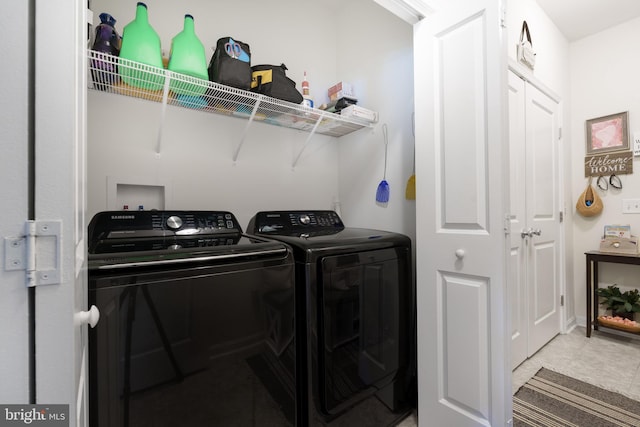 clothes washing area with washer and dryer